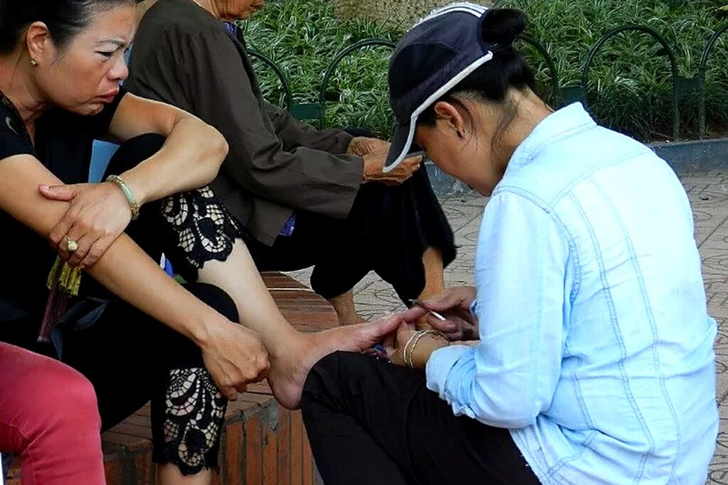 Pedicure al parco, nella totale indifferenza di chi passa